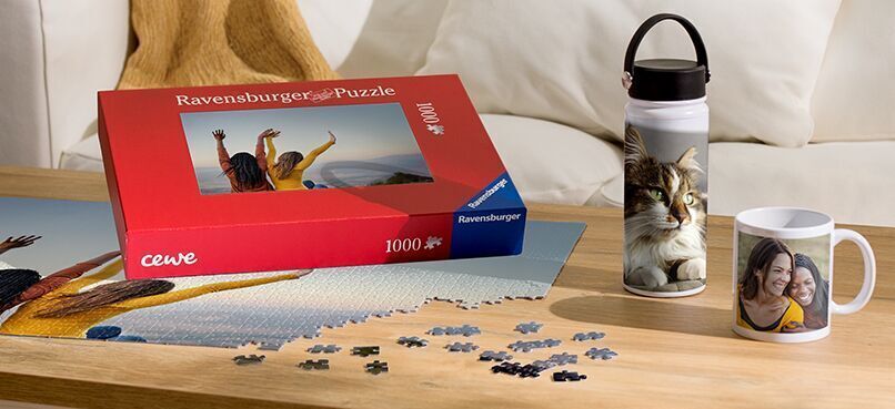 Beautiful puzzle box and personalized drinking vessel on a table.